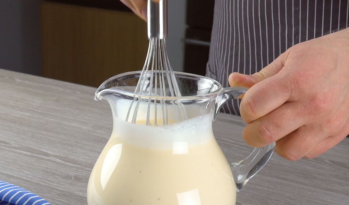 Kondensmilch, Sahne, Vanilleextrakt und Vanillecreme werden in einem Krug miteinander verrührt