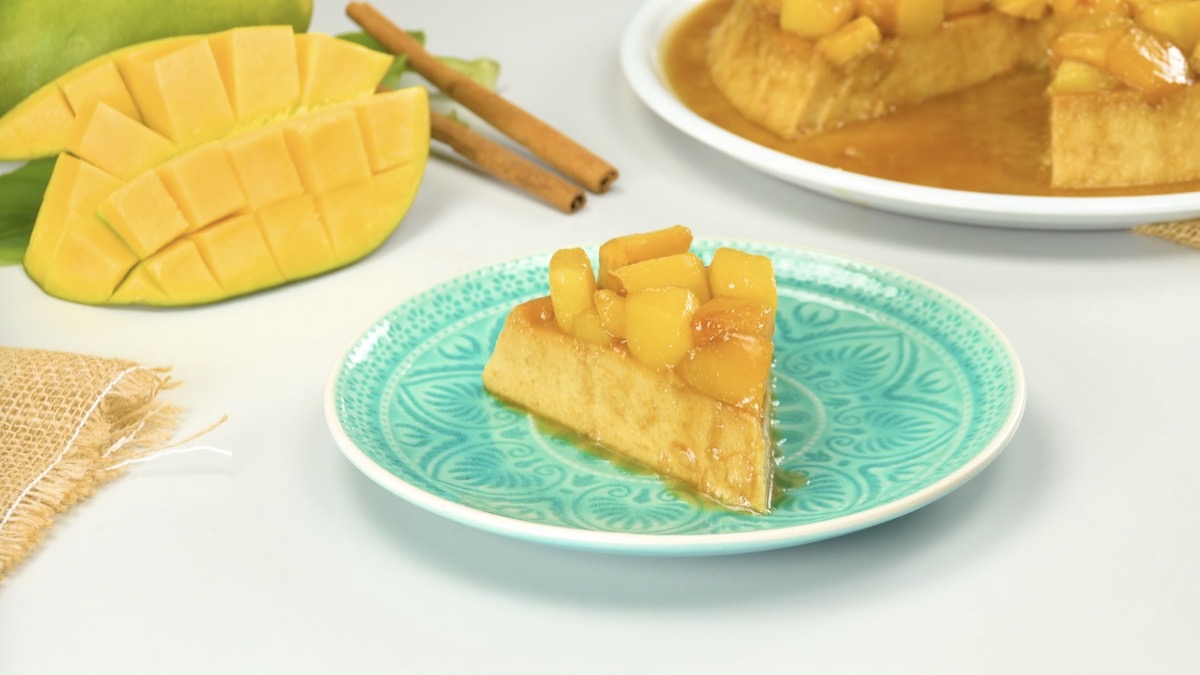 Ein Stück Mango-Flan auf türkisfarbenem Teller