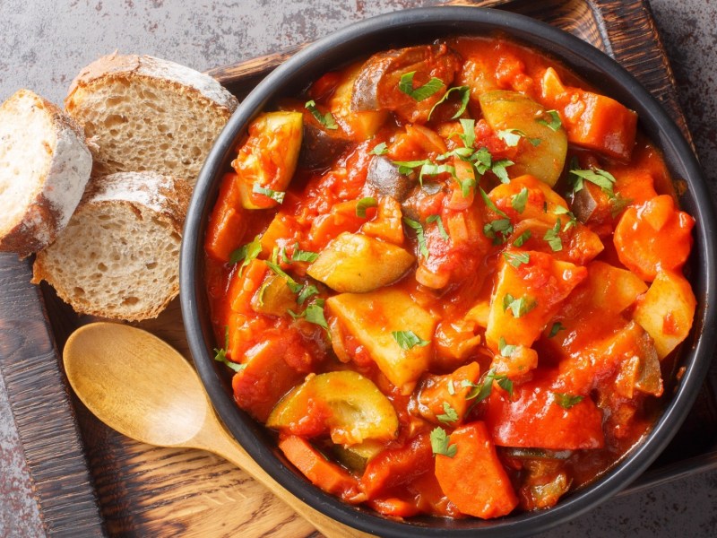 Vegetarisches Güvec in einem Topf mit Brot.