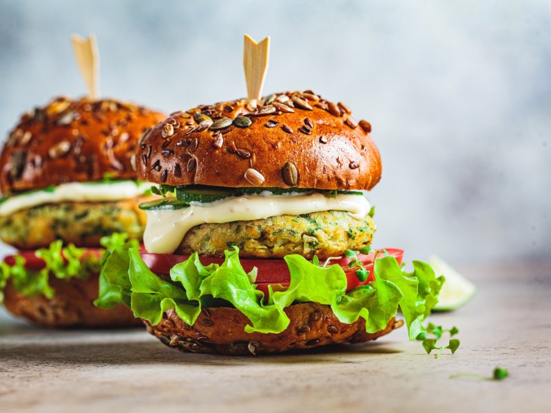 Zwei Falafel-Burger vor einem blauen Hintergrund.