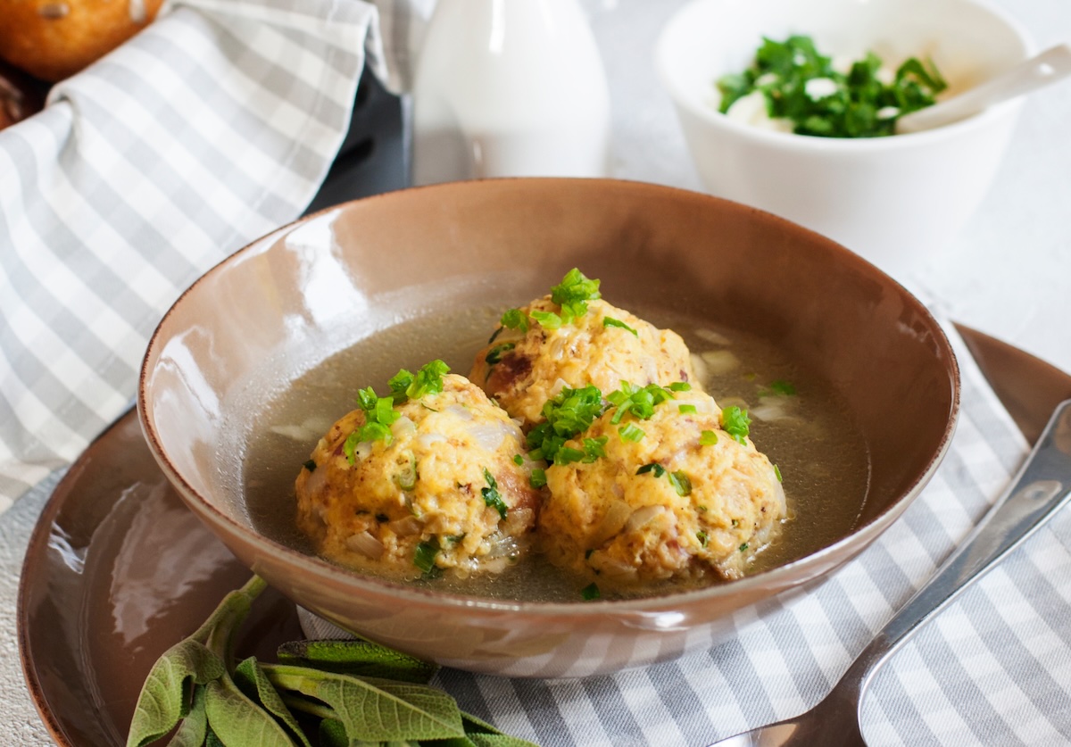3 Pilzknödel auf einem Teller mit Petersilie bestreut, Nahaufnahme.