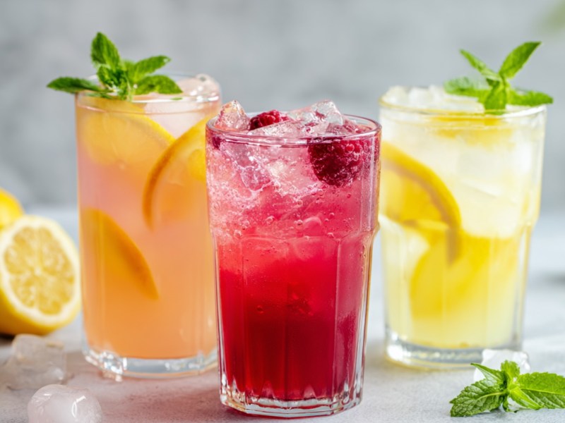 Drei Sommerlimonaden in hohen Gläsern.
