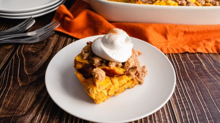 Eine Portion French-Toast-Auflauf mit Sahne auf einem Teller.
